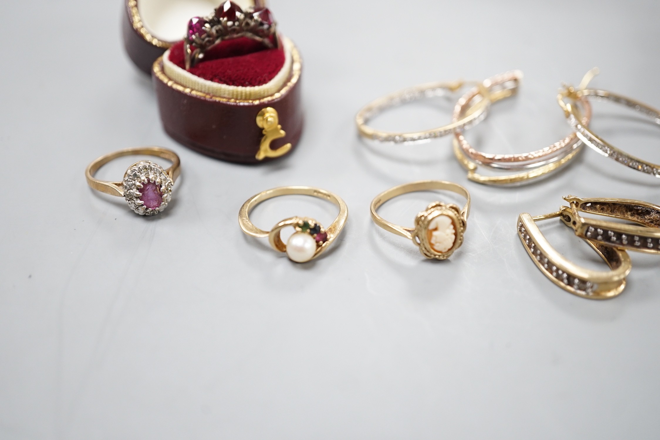 Six assorted modern 9ct gold and gem set rings, including white opal cluster and amethyst and diamond chip, a yellow metal and rose cut three stone garnet set ring, two pairs of modern 9ct gold earrings, including diamon